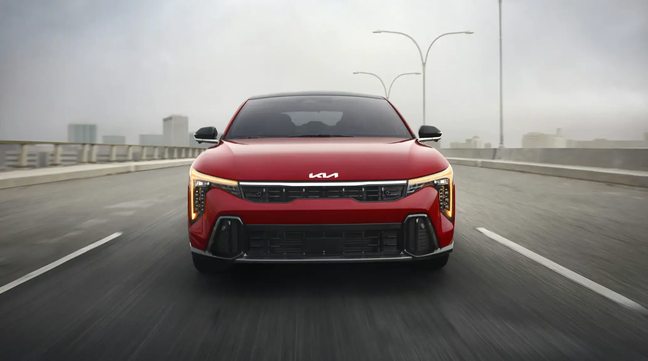 Front view of the 2027 Kia K4 with its slim grille and vertical daytime running lights