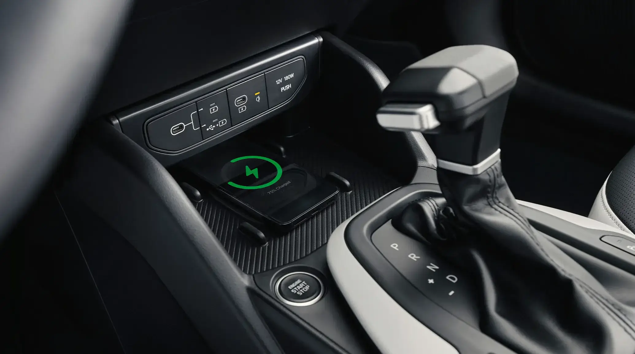 2027 Kia K4 center console with gear selector and wireless phone charging pad