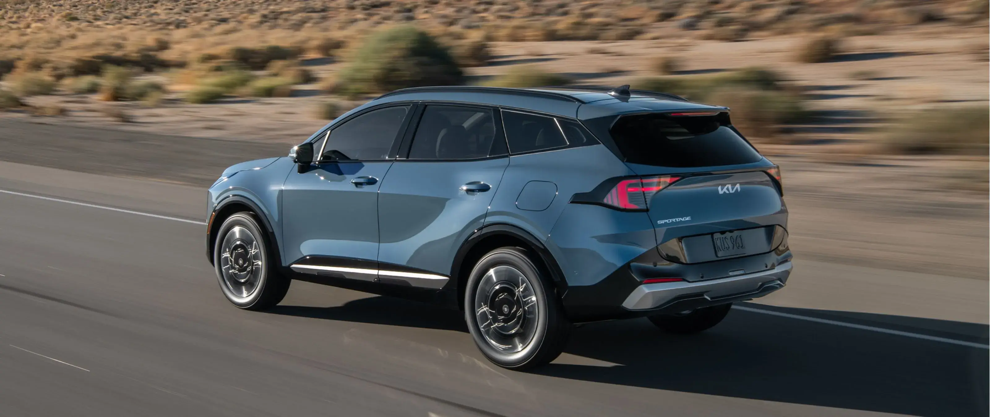 2027 Kia Sportage Hybrid driver side and rear three-quarter view showing the boxy upright profile