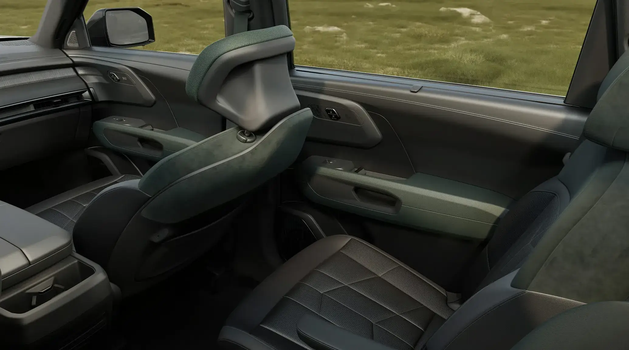 2027 Kia Telluride Hybrid interior viewed from the rear showing front seats and second-row captain's chairs