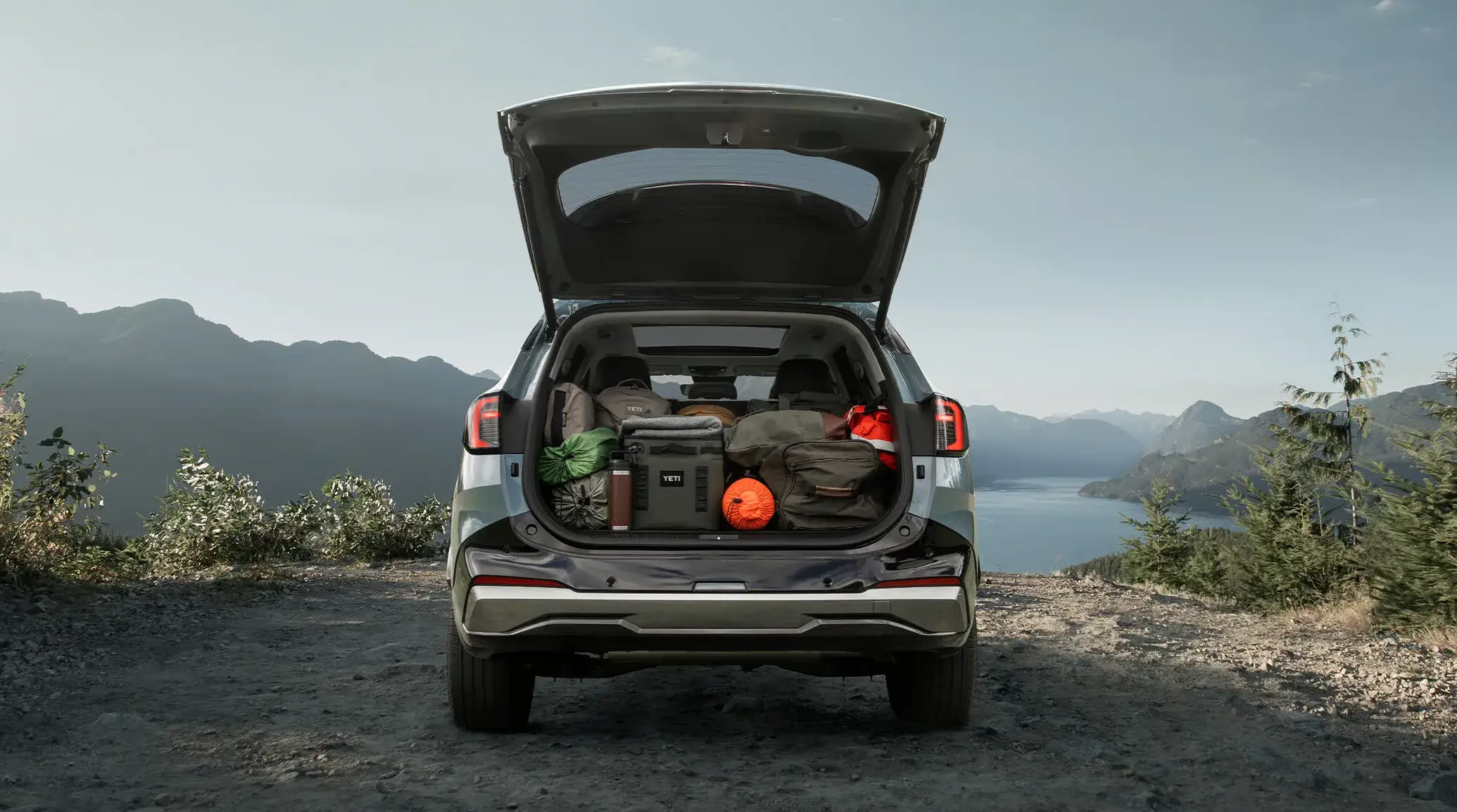 Open cargo area of the 2027 Kia Sportage Hybrid loaded with luggage showing the dual-level cargo floor