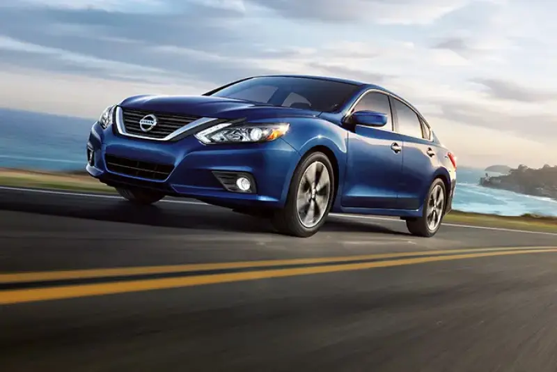 Blue Nissan sedan on a road