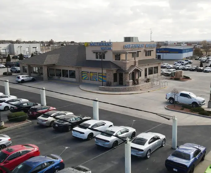 Southwest Motors dealership exterior with parking lot and vehicles.