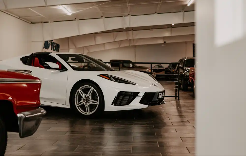 White sports car displayed inside the Tailgate Motor Co. showroom