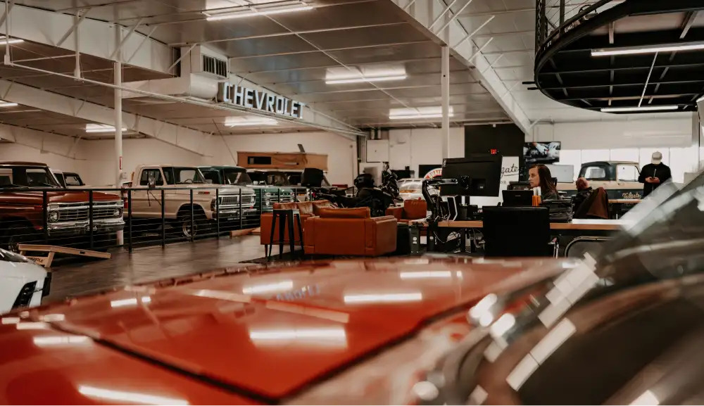 Tailgate Motor Co. showroom with classic trucks and customer lounge area