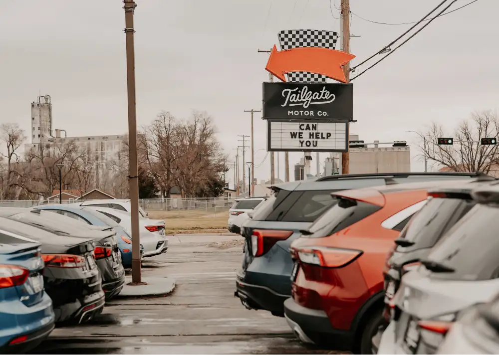 Tailgate Motor Co. lot with dealership sign and vehicles for sale