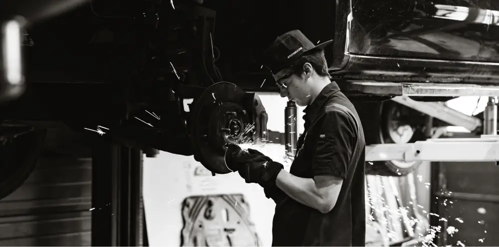 Tailgate Garage technician working on a vehicle in the service bay