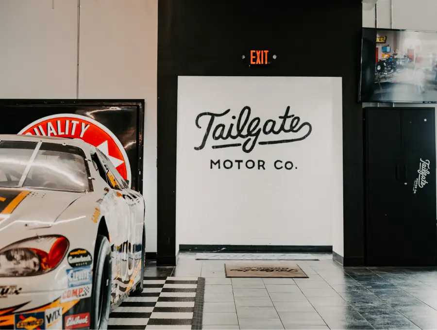 Tailgate Motor Co. logo wall inside the dealership showroom