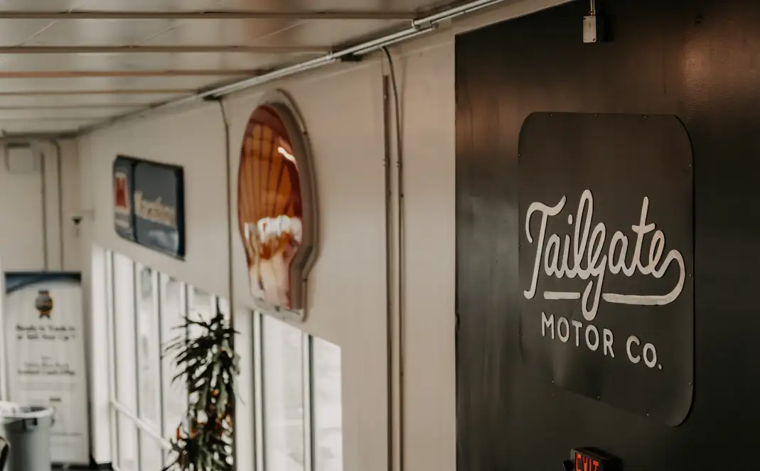 Tailgate Motor Co. logo sign inside the dealership