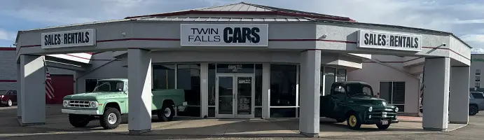 Exterior of Twin Falls Cars Sales & Rentals with classic Dodge Pickup Trucks.