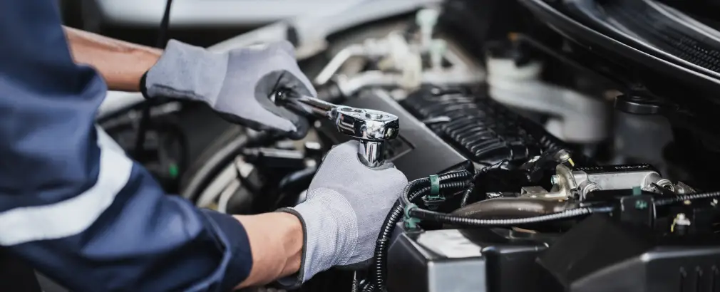 Technician servicing a vehicle at an auto service center in Mesa, AZ