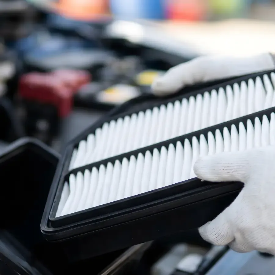 Technician replacing an engine air filter at Ultimate Powersports.