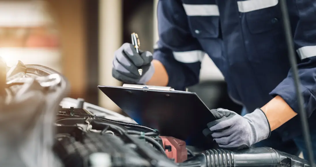 Automotive technician giving a thumbs-up in the Ultimate Powersports service center