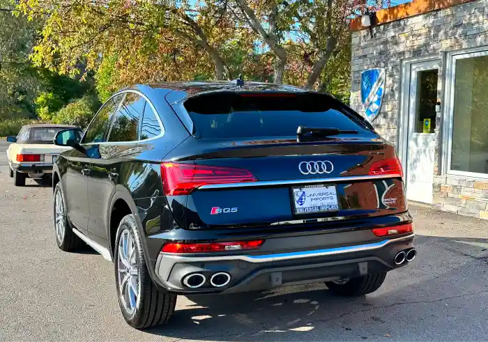 Black Audi SQ5 parked outside dealership building