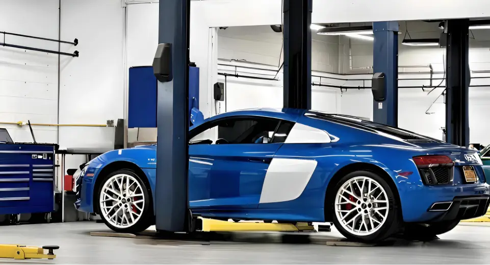 Blue Audi sports car inside a service bay at Universal Imports.