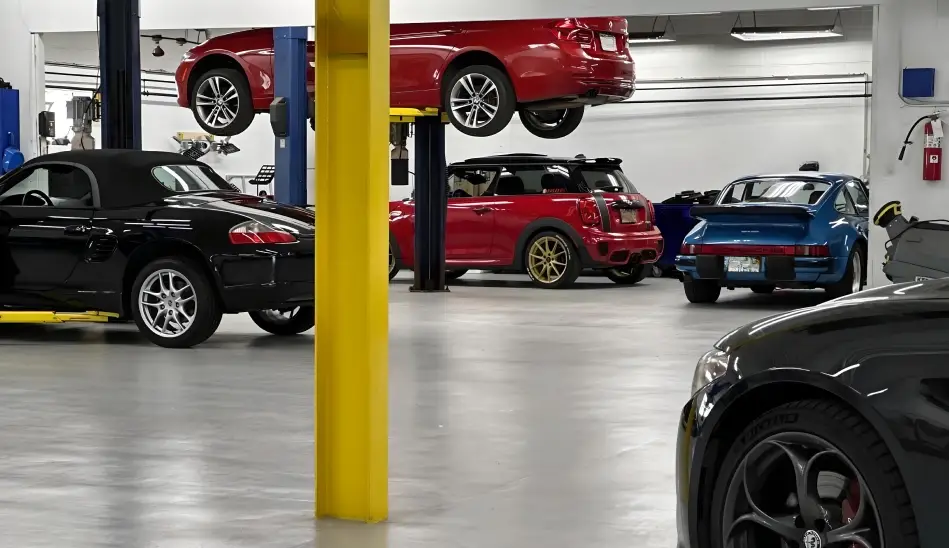 Auto service shop with multiple vehicles on lifts undergoing maintenance