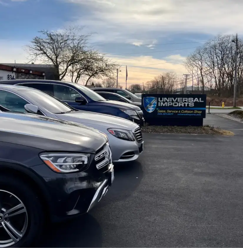 Row of vehicles parked at Universal Imports dealership lot.