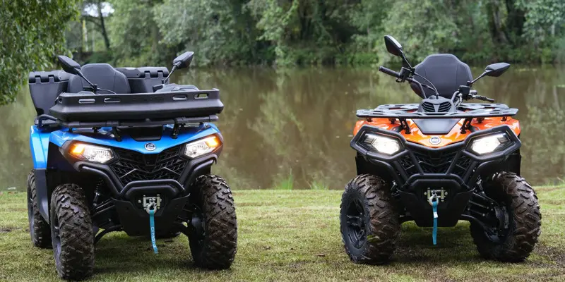 two atvs sitting side by side