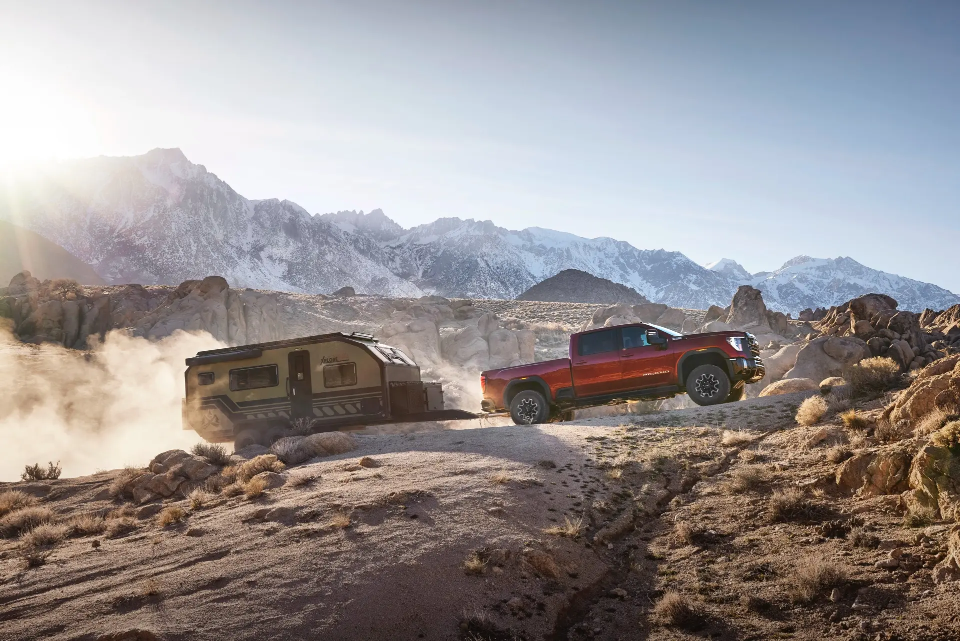 Truck Towing a Camper on Rocky Terrain