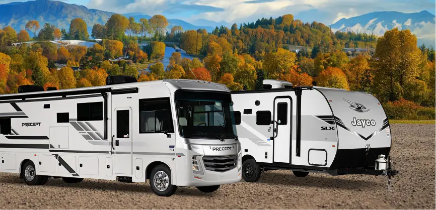 RV & trailer setup in a field for camping