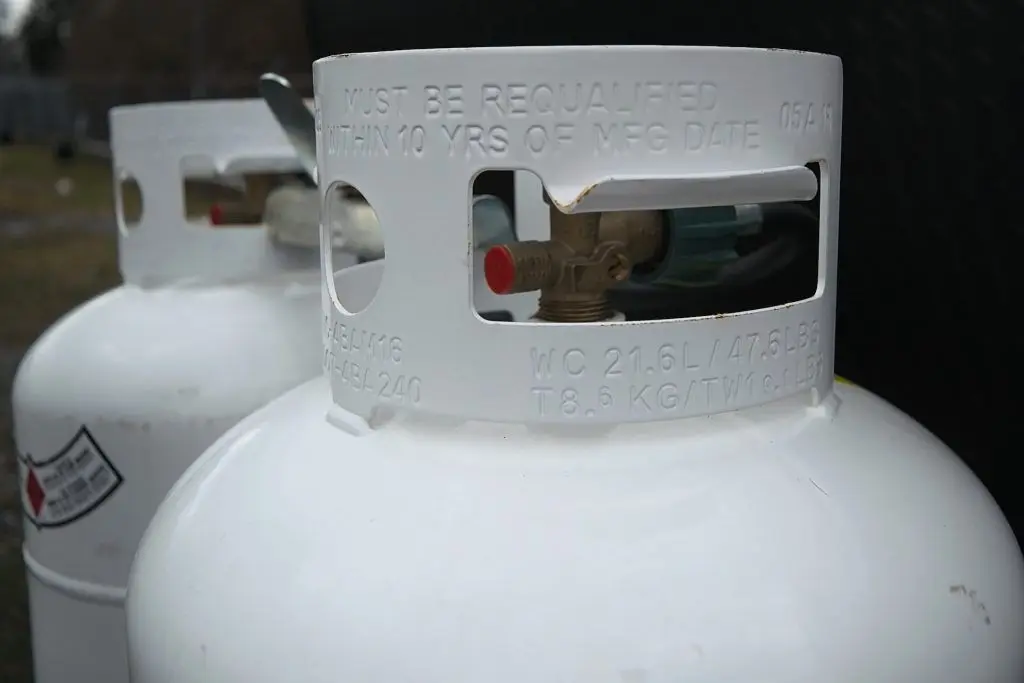 Two 20 pound propane tanks secured to the front of an RV travel Trailer