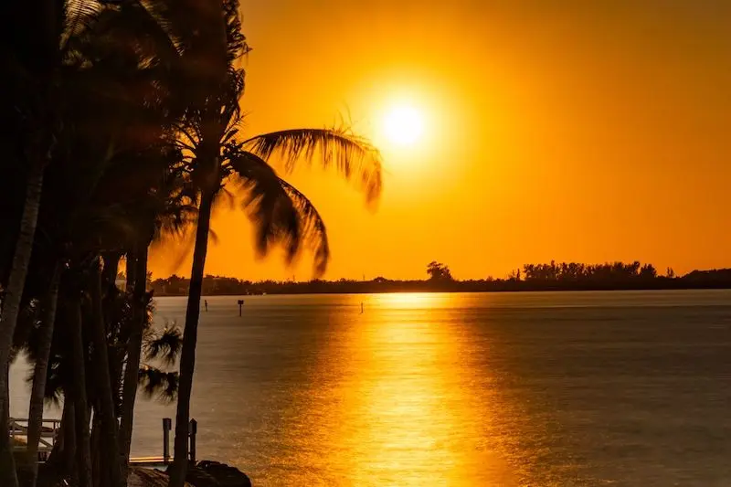 Orange sunset at Siesta Key beach with sunshine, Sarasota, Florida