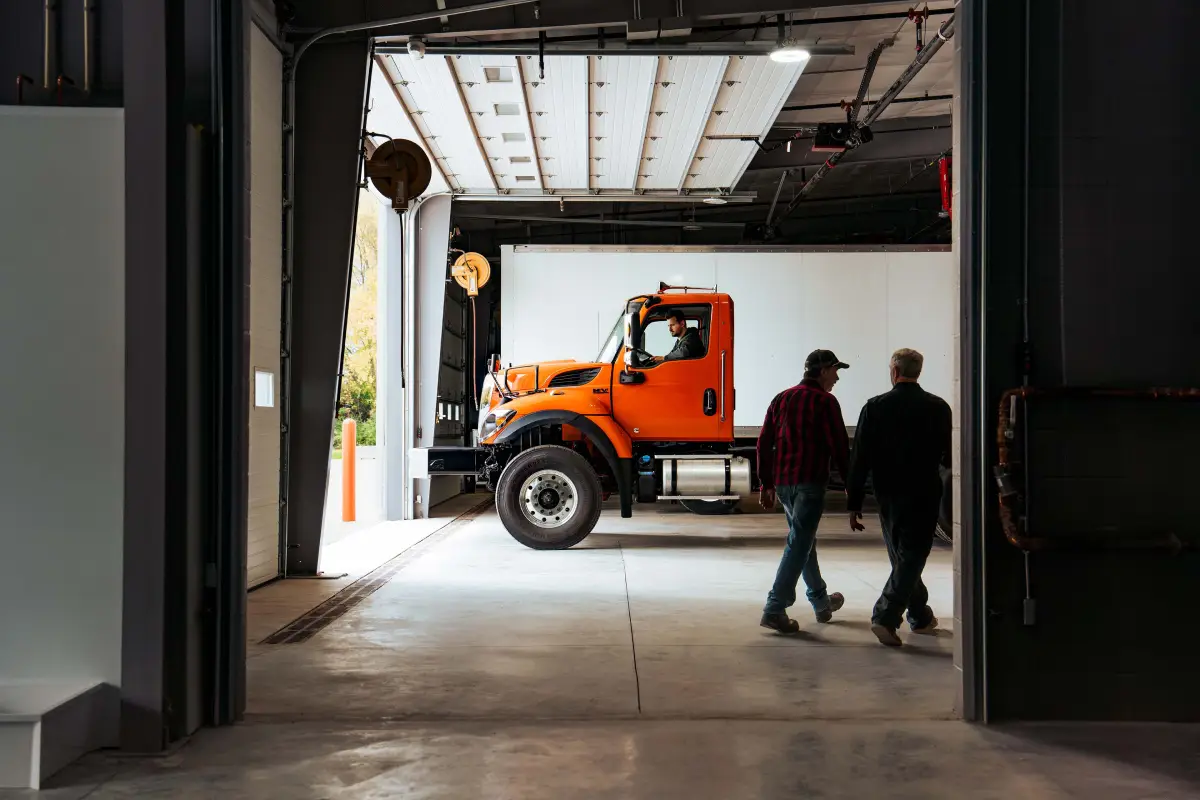 Team Wieland Truck & Trailer service bay technician assisting a customer
