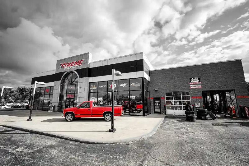 Xtreme Truck & Auto Center storefront with a red pickup parked outside