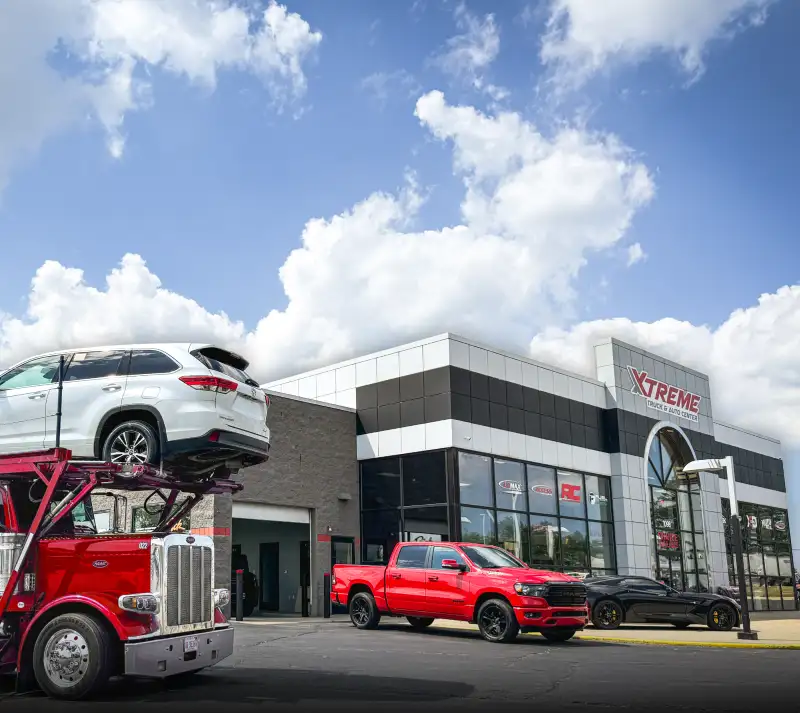 Xtreme Truck & Auto Center storefront with trucks displayed outside