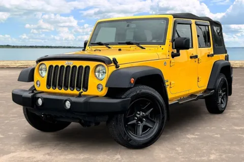 Yellow 2015 Jeep Wrangler Unlimited Sport for sale in Jacksonville, FL