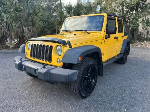Yellow 2015 Jeep Wrangler Unlimited Sport for sale in Jacksonville, FL