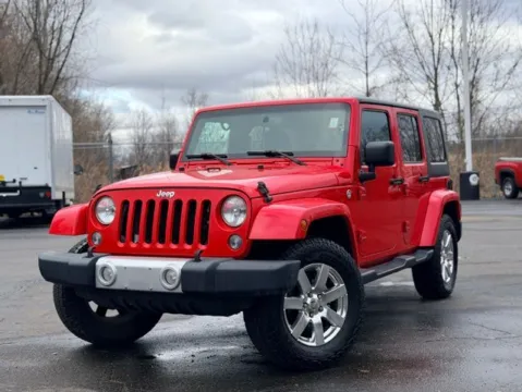 Red 2015 Jeep Wrangler Unlimited Sahara for sale in Davison, MI
