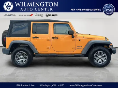 Orange 2012 Jeep Wrangler Unlimited Sport for sale in Wilmington, OH
