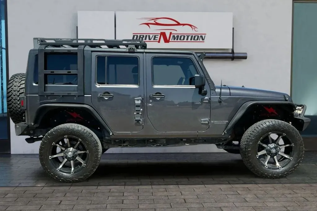 Another view of 2014 Jeep Wrangler Unlimited Sport SUV 4D for sale in Thornton, CO at Drive N-Motion Thornton