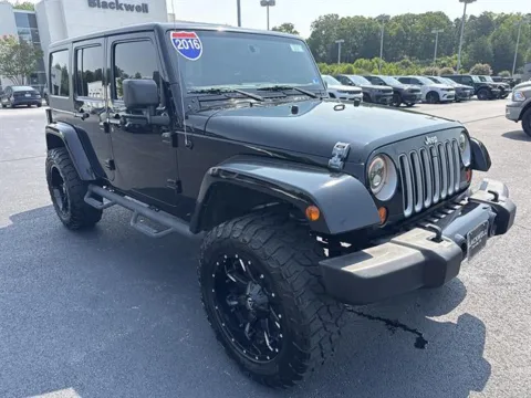 Black 2016 JEEP WRANGLER UNLIMI 4x4 Sahara 4dr SUV for sale in Danville, VA
