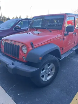 Orange 2015 Jeep Wrangler Unlimited Sport for sale in Grandville, MI