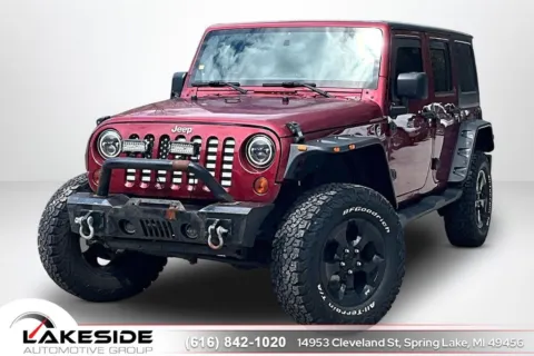 Red 2012 Jeep Wrangler Unlimited Sahara for sale in Spring Lake, MI