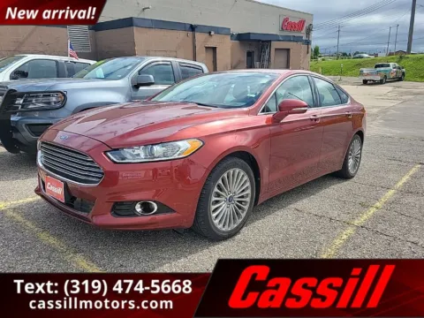 Orange 2014 Ford Fusion Titanium for sale in Cedar Rapids, IA