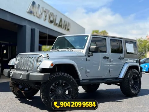 Silver 2014 Jeep Wrangler Unlimited Freedom Edition for sale in Jacksonville, FL