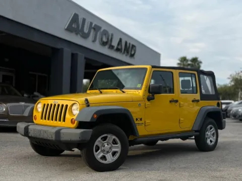 Yellow 2009 Jeep Wrangler Unlimited X for sale in Jacksonville, FL