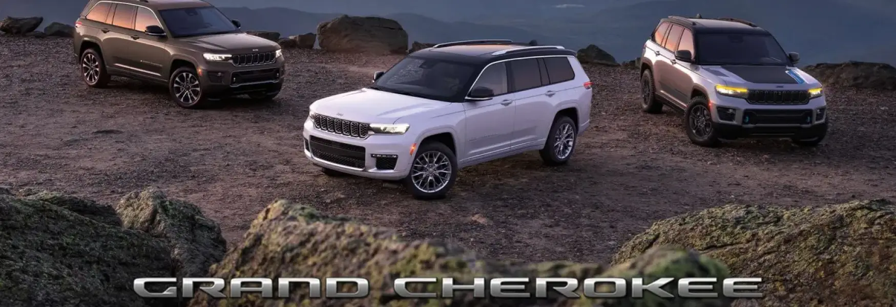 2025 Jeep Grand Cherokee parked on a scenic road showcasing its iconic profile