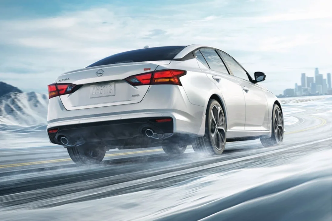 Nissan Altima driving on snowy road showcasing performance and handling