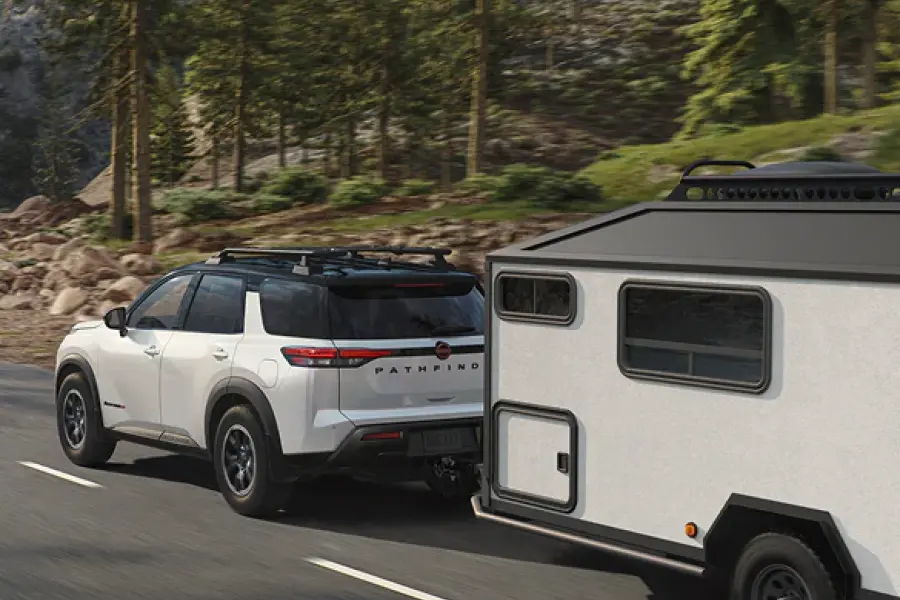 2025 Nissan Pathfinder towing a trailer on the highway